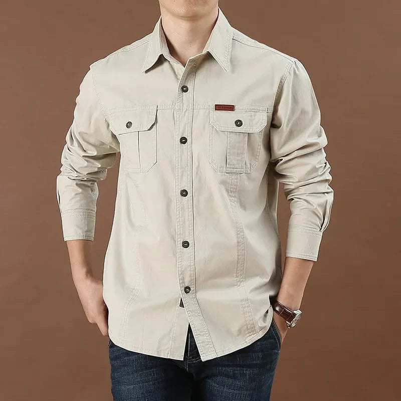Beige button-up adventure shirt with dual chest pockets and button cuffs