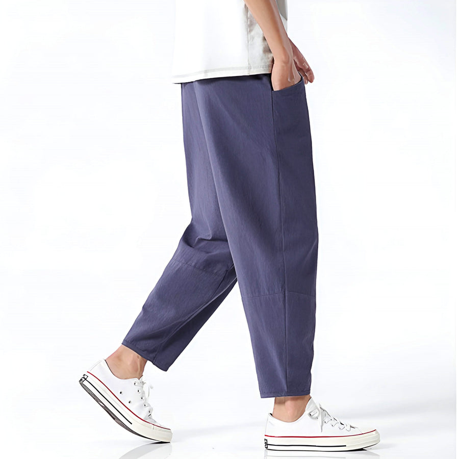 Indigo cropped cotton pants, side view with relaxed fit and cuffed hem
