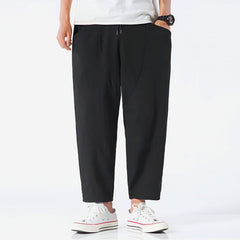 Black cropped cotton pants with drawstring waist and straight tapered legs