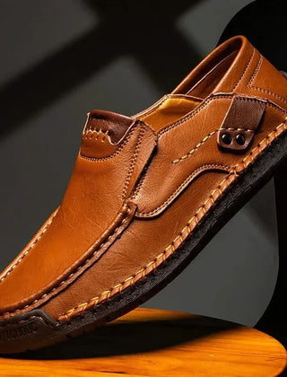 Orange-brown leather slip-on loafer with metal bit detail and stitched edges