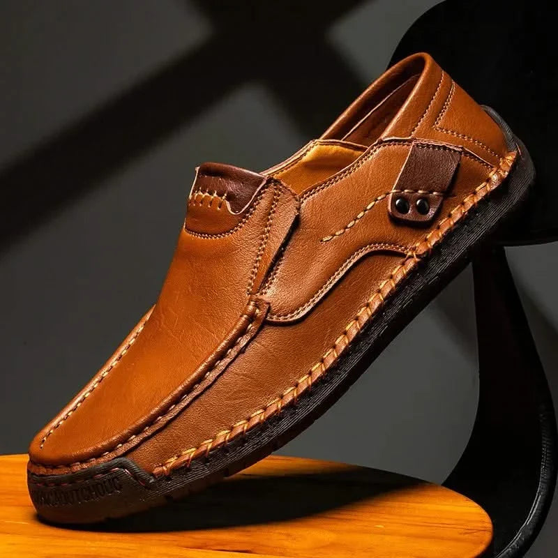 Orange-brown leather slip-on loafer with metal bit detail and stitched edges