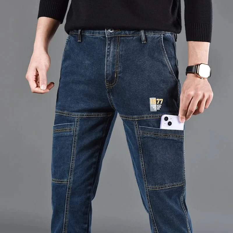 Blue utility jeans with button waist, front cargo pockets, and stitched panels