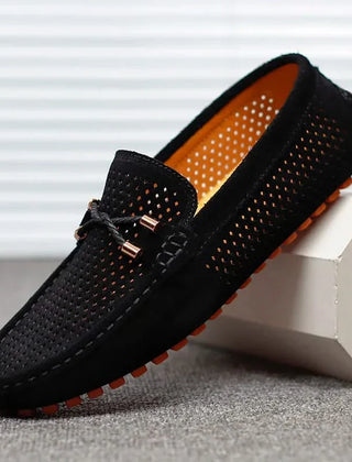 Black perforated leather loafer slip-on with metal bar detail and moccasin stitching