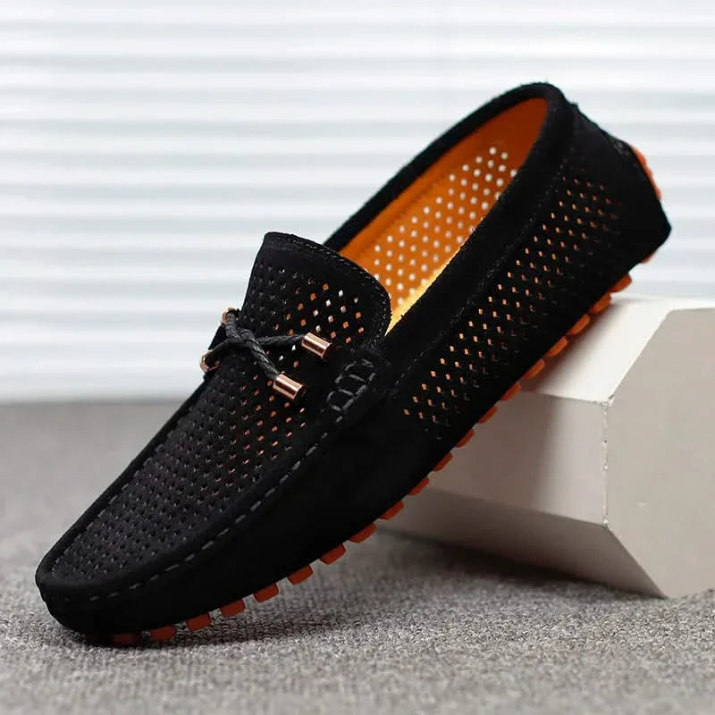 Black perforated leather loafer slip-on with metal bar detail and moccasin stitching