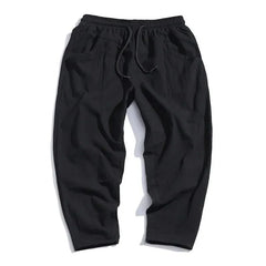 Black cropped cotton pants, flat lay with elastic waistband and gathered front