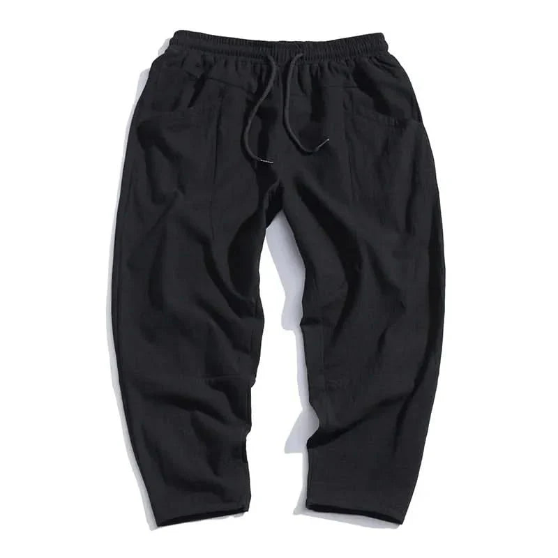 Black cropped cotton pants, flat lay with elastic waistband and gathered front