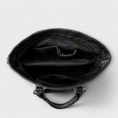 Brown leather handbag with top handles and detachable crossbody strap; includes card insert