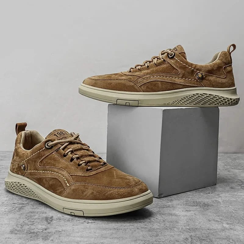 Brown suede lace-up sneakers with tan laces and perforated rubber side trim
