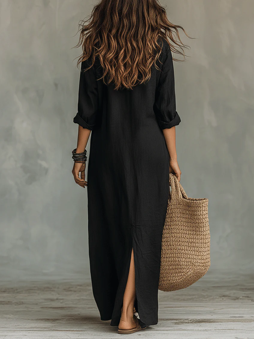Black button-front maxi dress from back view, three-quarter sleeves, side slit