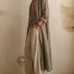 Layered three-piece set: patterned vest under olive long shirt, linen drawstring pants
