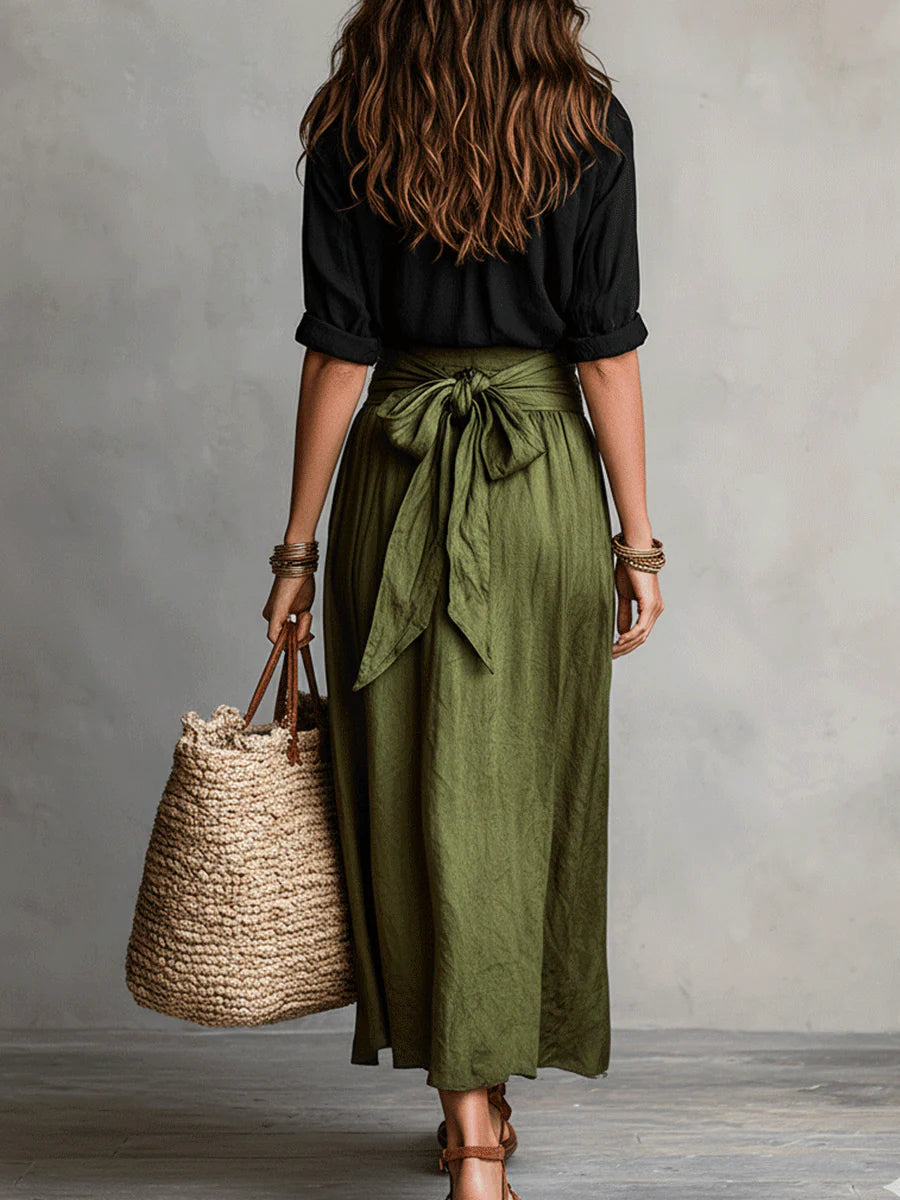 Two-piece set: back of black blouse with olive green midi skirt and bow