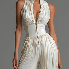 White pleated chiffon halter jumpsuit with deep V front zip and gathered waist