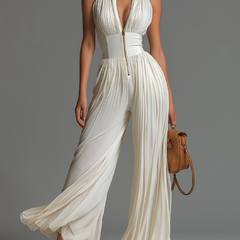 White pleated chiffon halter jumpsuit with deep V neckline and wide legs