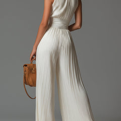 White pleated chiffon halter jumpsuit, back view with gathered waist and wide legs