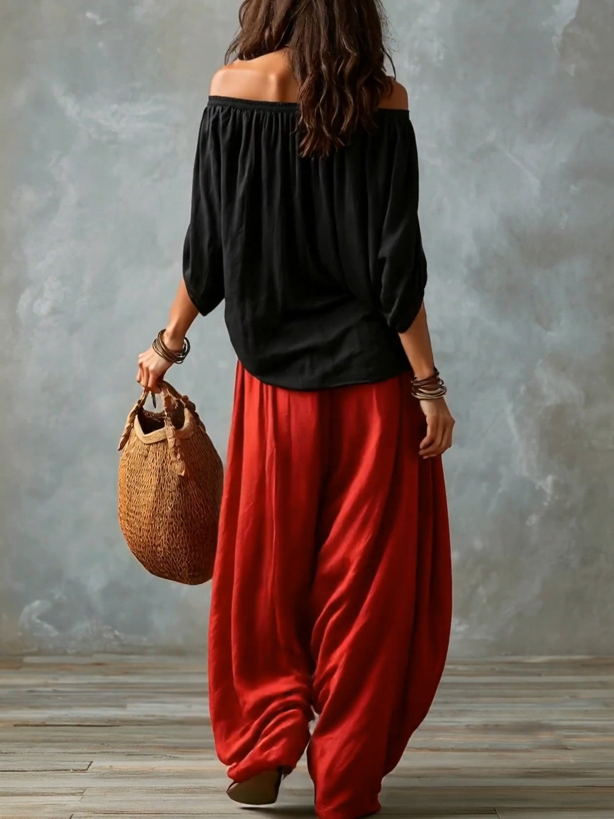 Black off-shoulder top with red lantern trousers, back view