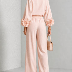 Blush two-piece set: back view of long-sleeve blouse and wide-leg pants with floral cuffs