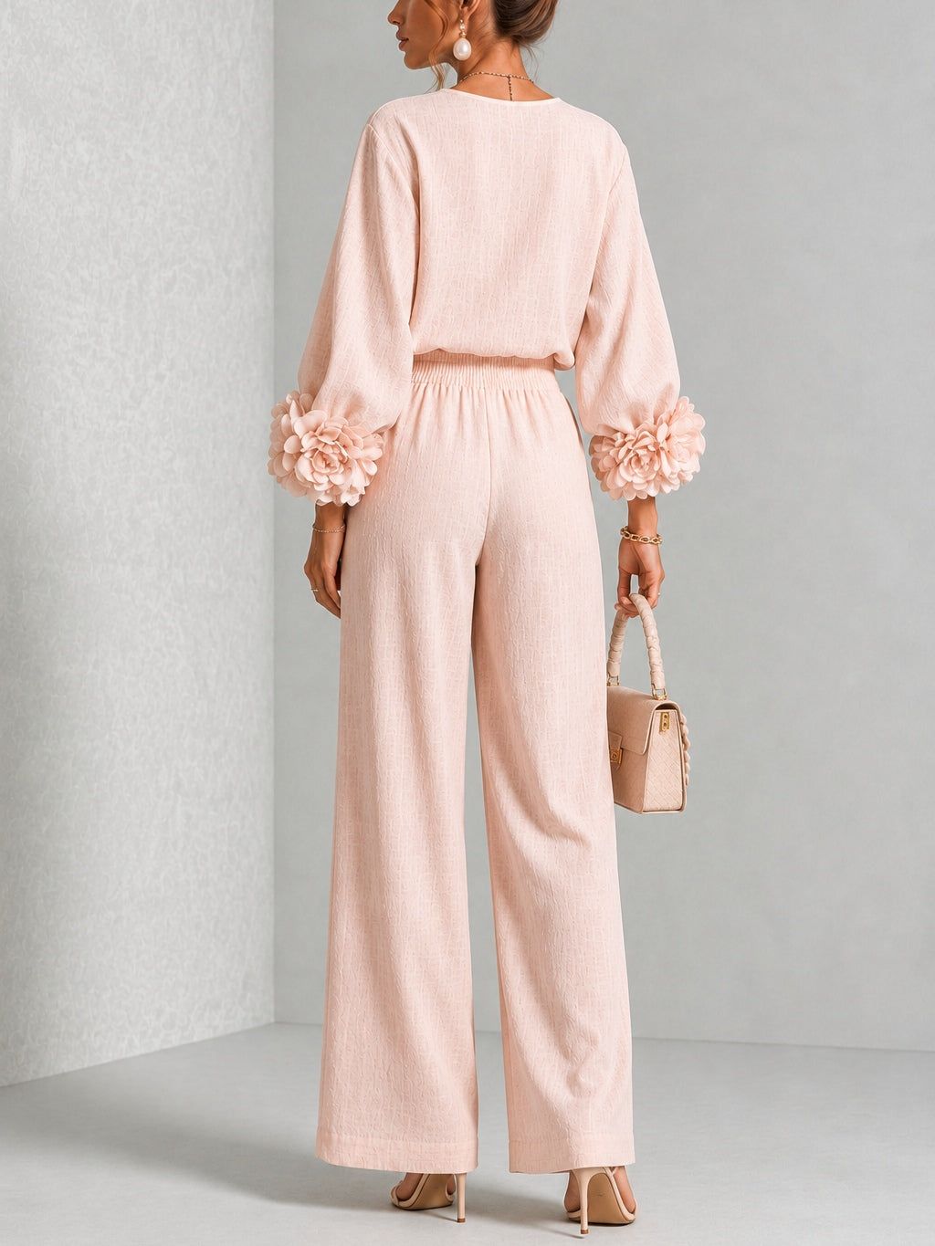 Blush two-piece set: back view of long-sleeve blouse and wide-leg pants with floral cuffs