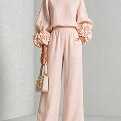 Blush two-piece set: long-sleeve blouse and wide-leg pants with floral cuff details
