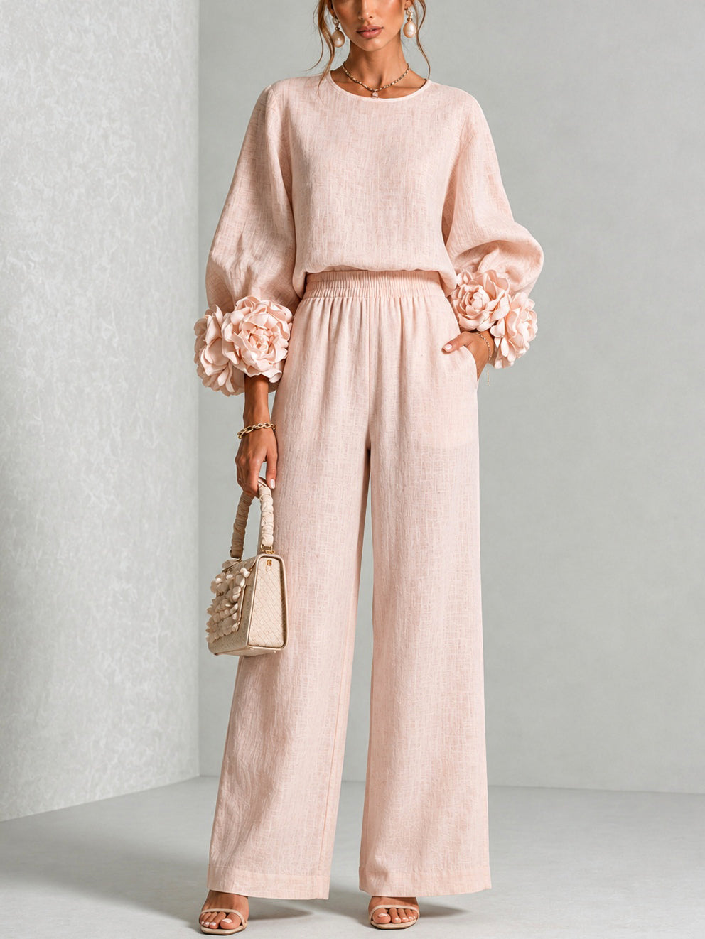 Blush two-piece set: long-sleeve blouse and wide-leg pants with floral cuff details