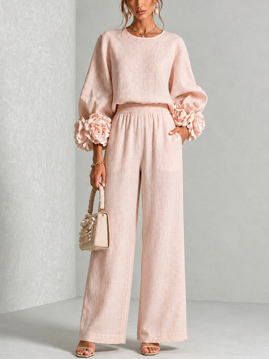 Blush two-piece set: long-sleeve blouse and wide-leg pants with floral cuff details