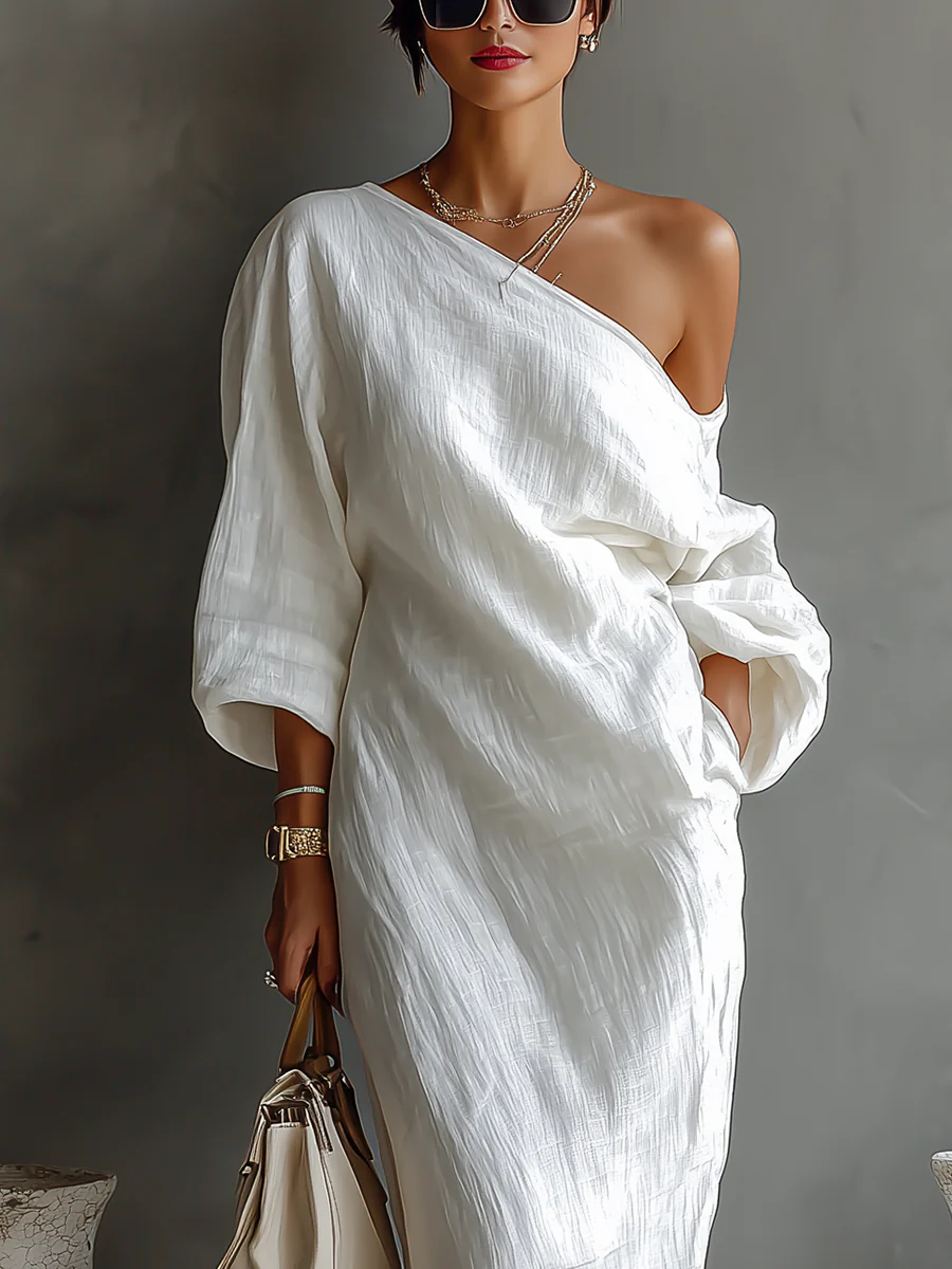 White one-shoulder maxi dress with draped sash waist and flowing off-shoulder sleeve
