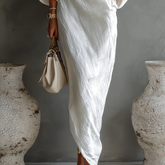 White one-shoulder maxi dress with wrap drape front and bracelet-length sleeves