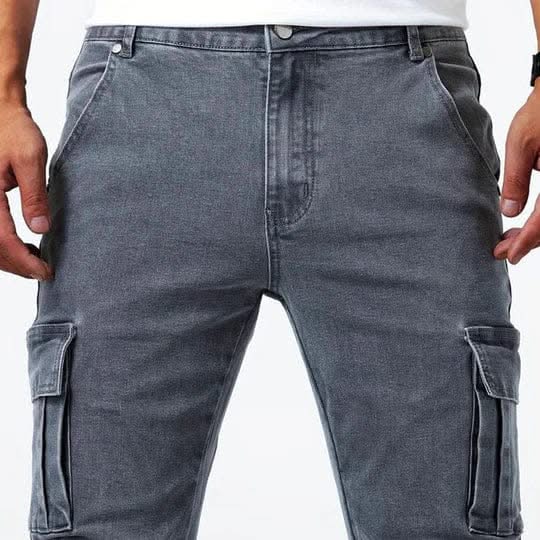 Dark grey utility jeans close-up with button fly and side cargo pockets
