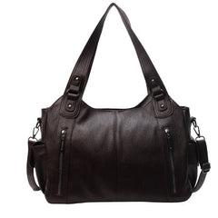 Brown leather hobo handbag with dual top handles, side zips, and shoulder strap