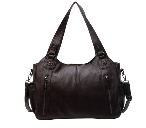 Brown leather hobo handbag with dual top handles, side zips, and shoulder strap
