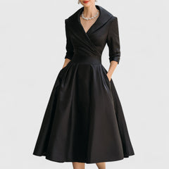 Black midi dress with surplice V-neck, three-quarter sleeves, and gathered full skirt