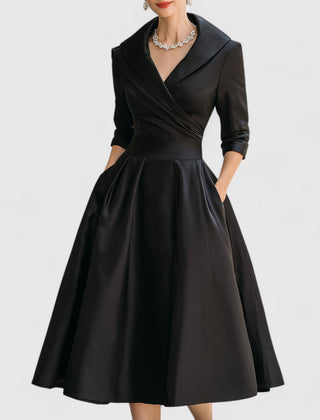 Black midi dress with surplice V-neck, three-quarter sleeves, and gathered full skirt