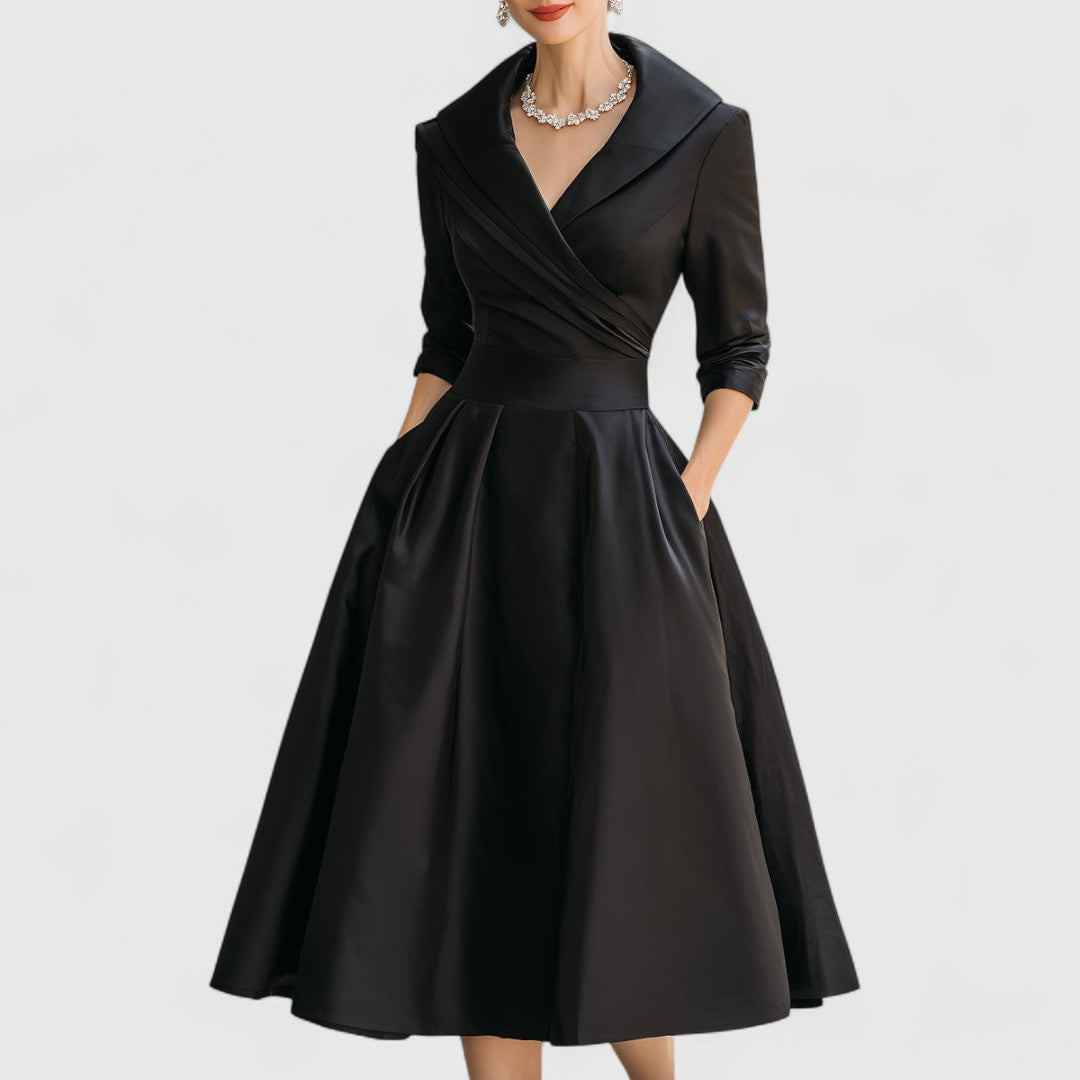 Black midi dress with surplice V-neck, three-quarter sleeves, and gathered full skirt