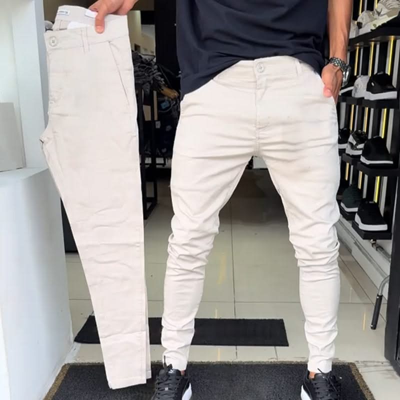 Off-white slim trousers with tapered legs, button waist, and side pockets