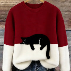 Red oversized fuzzy sweater with black-and-white penguin applique and white hem detail