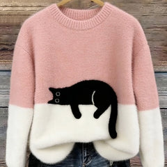 Pink oversized fuzzy sweater with black-and-white penguin applique and white hem