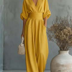 Yellow V-neck high-waisted jumpsuit with elastic waist and wide-leg pant legs