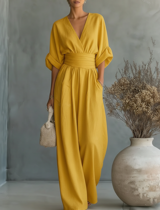 Yellow V-neck high-waisted jumpsuit with elastic waist and wide-leg pant legs