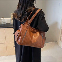 RAE Classic leather handbag in tan-brown leather with front zips and adjustable shoulder strap