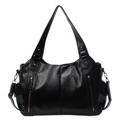 Black leather hobo handbag with dual handles, side zippers, and crossbody shoulder strap