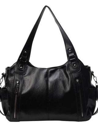 Black leather hobo handbag with dual handles, side zippers, and crossbody shoulder strap