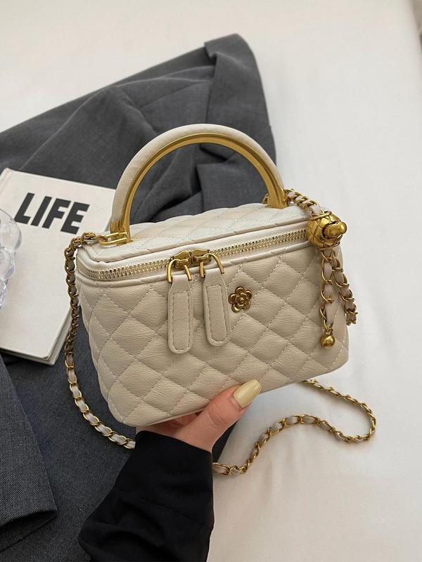 White quilted crossbody bag with gold-tone chain, rounded top handle, zip closure