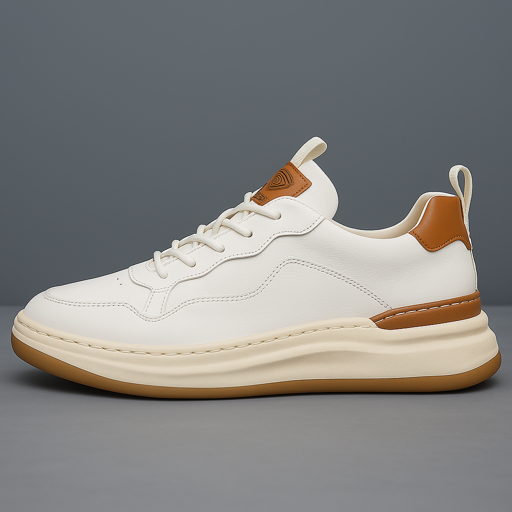 White leather low-top sneaker with lace-up front, tan heel patch, and gum sole