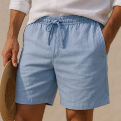 Blue drawstring shorts with elastic waistband and stitched side seams
