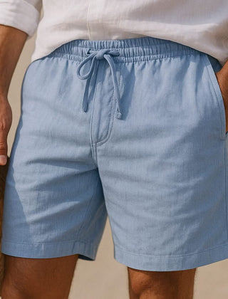 Blue drawstring shorts with elastic waistband and stitched side seams