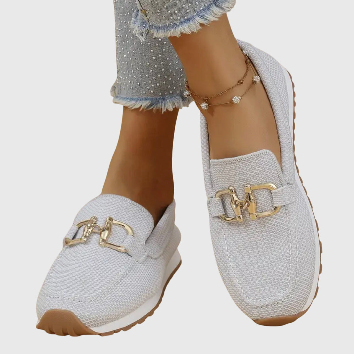 White orthopedic loafer sneakers with gold-tone buckle detailing and cushioned lining