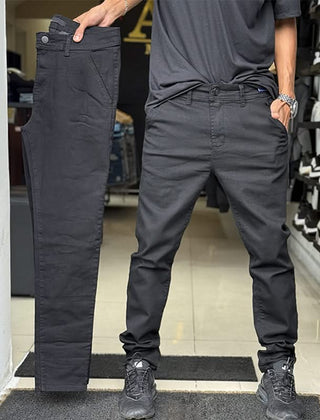Dark grey slim trousers with tapered legs, button waist, and side pockets