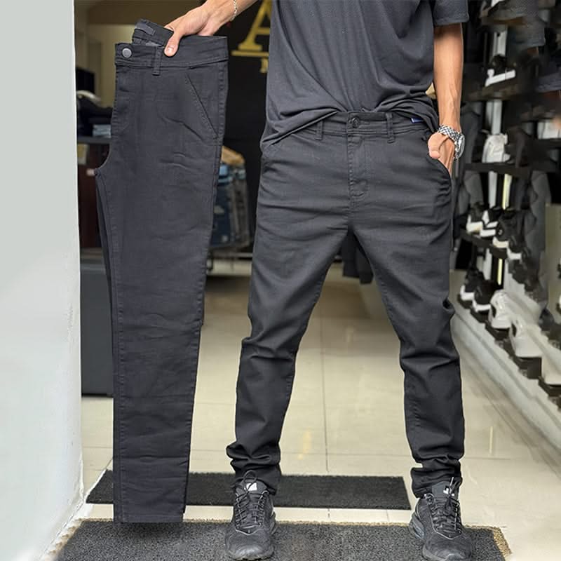 Dark grey slim trousers with tapered legs, button waist, and side pockets