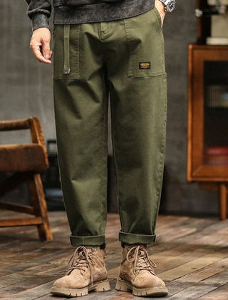 Army green cargo pants with side pockets and relaxed straight legs