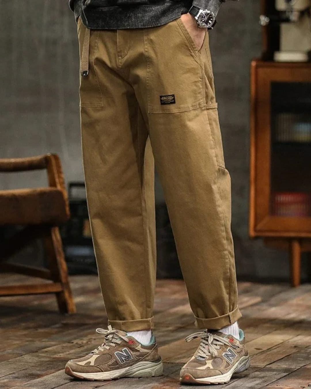 Tan cargo pants with front pleats, side cargo pocket, and cuffed hem
