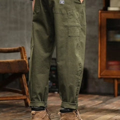 Olive green cargo pants with button fly and cargo pocket on thigh